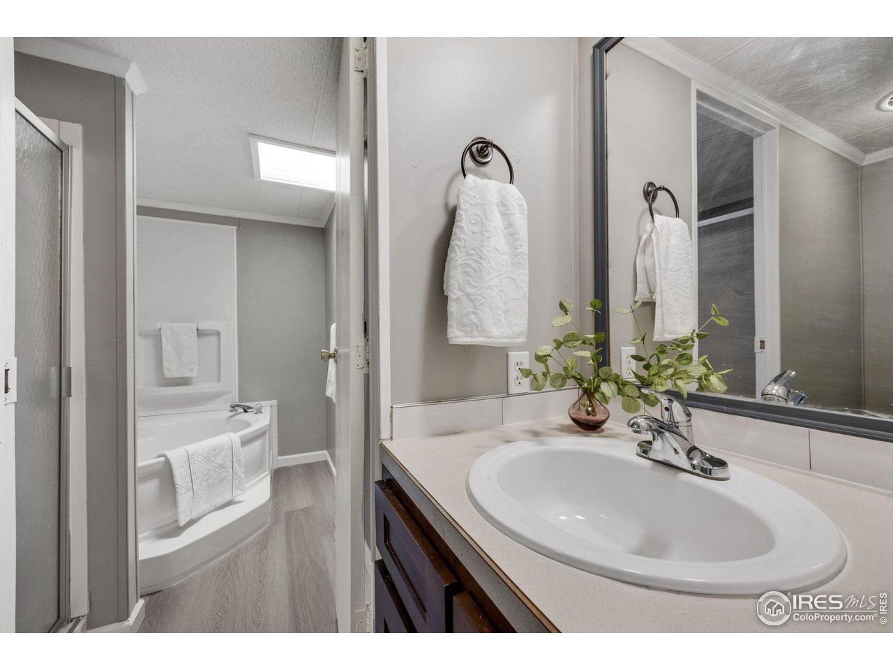 517 East Trilby Road, Unit 102 Fort Collins, CO 80525 - Photo 16 of 19 a bathroom with a sink and a mirror