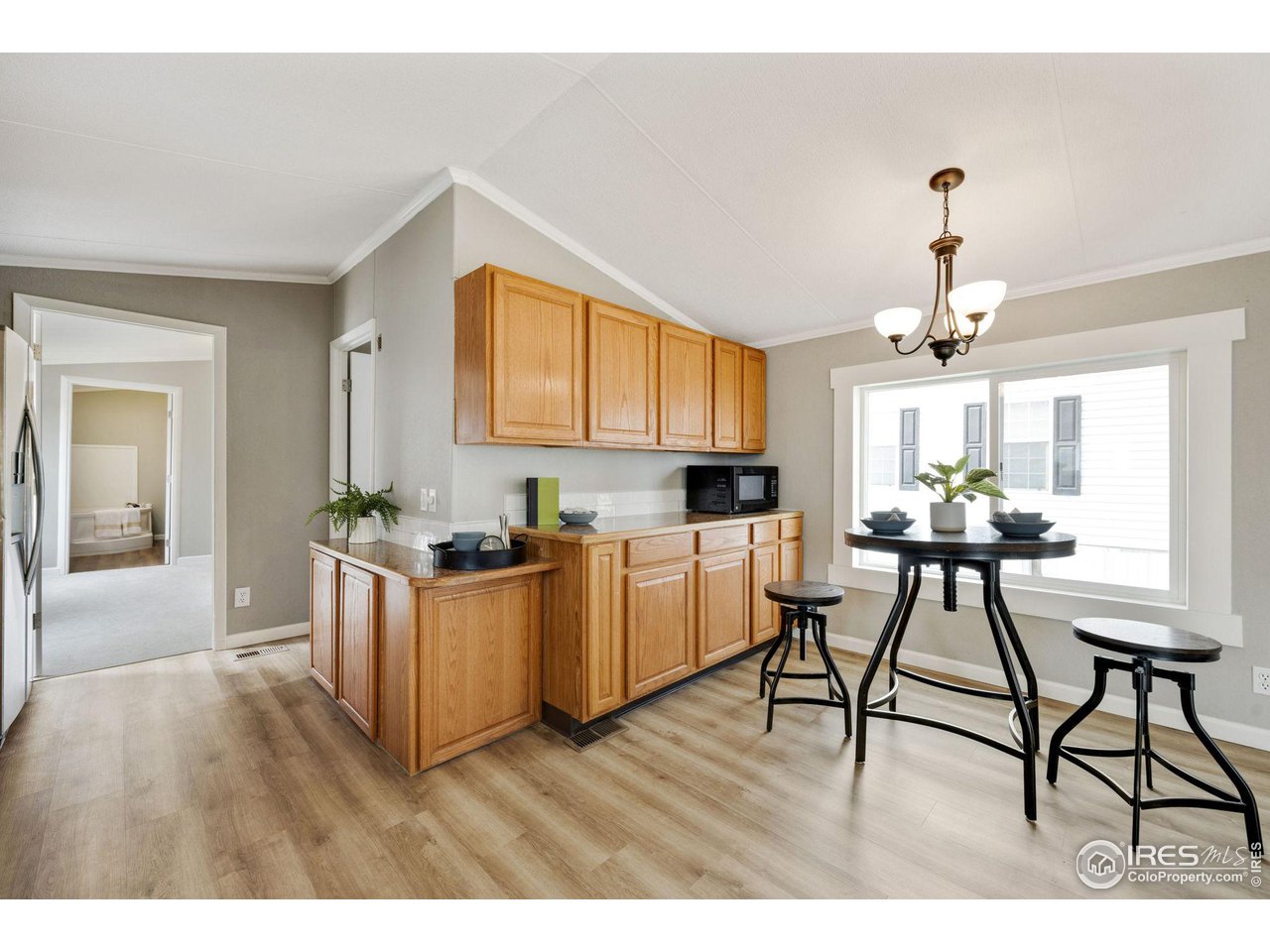 517 East Trilby Road, Unit 102 Fort Collins, CO 80525 - Photo 5 of 19 a living room with kitchen island furniture and a chandelier