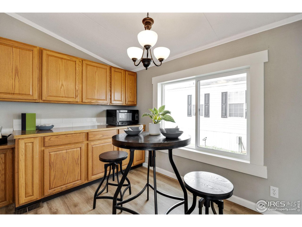 517 East Trilby Road, Unit 102 Fort Collins, CO 80525 - Photo 6 of 19 a kitchen with stainless steel appliances a table and chairs in it