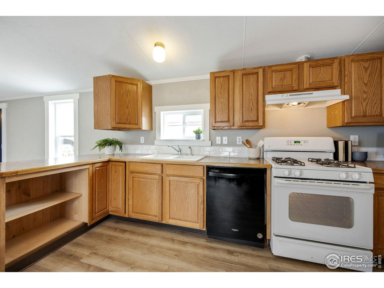 517 East Trilby Road, Unit 102 Fort Collins, CO 80525 - Photo 7 of 19 a kitchen with a stove sink and cabinets