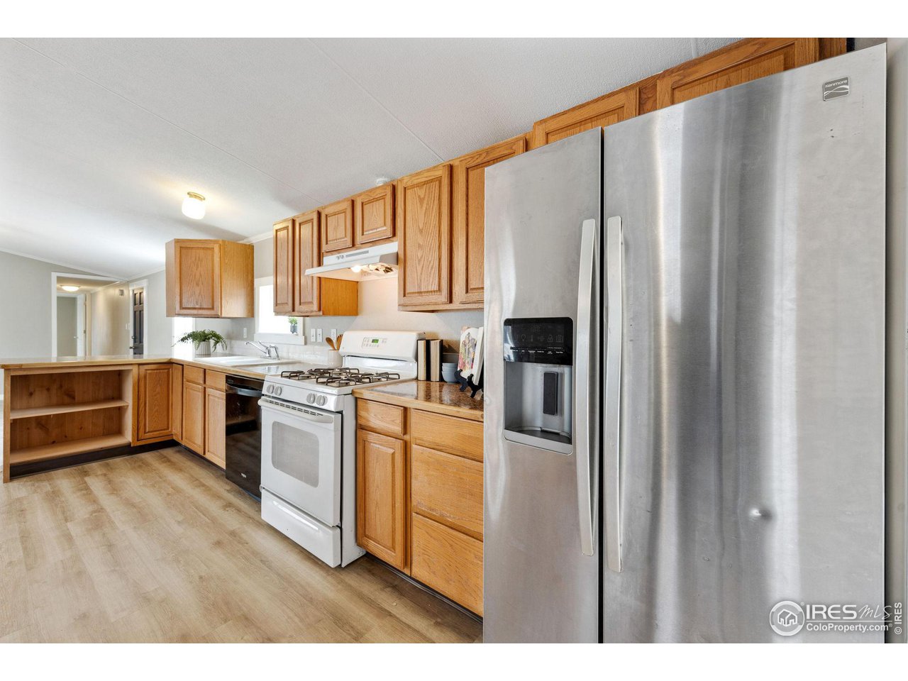 517 East Trilby Road, Unit 102 Fort Collins, CO 80525 - Photo 8 of 19 a kitchen with stainless steel appliances a refrigerator and a stove top oven