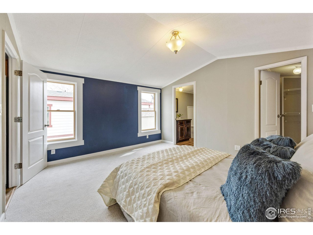 517 East Trilby Road, Unit 102 Fort Collins, CO 80525 - Photo 10 of 19 a bedroom with a bed and a chandelier