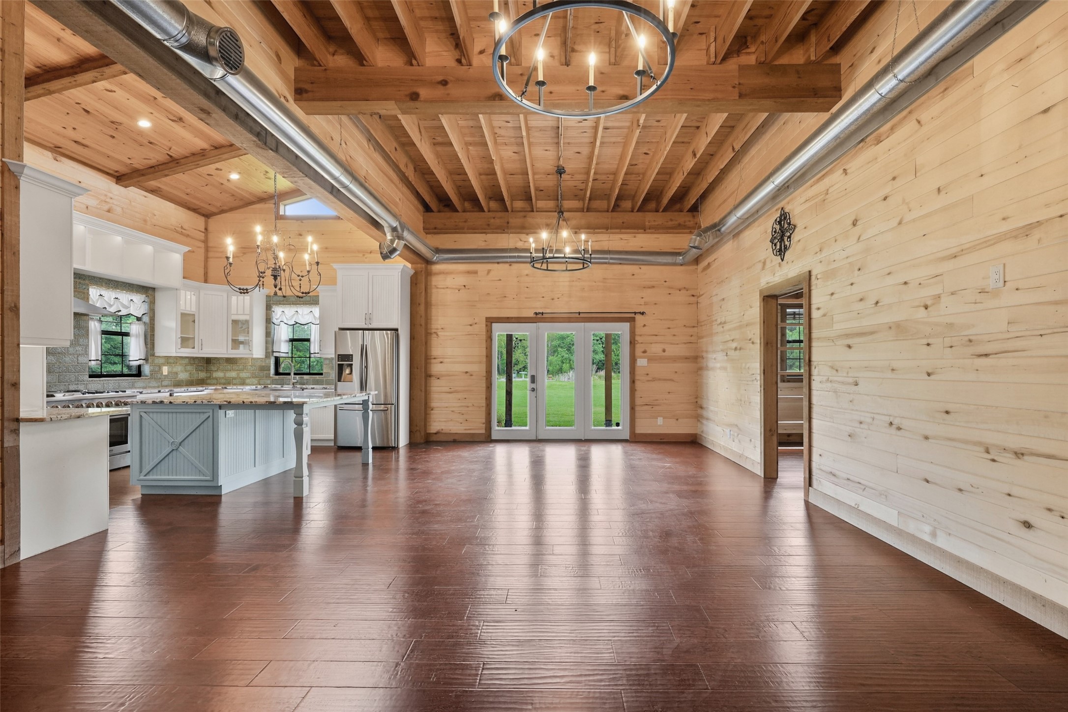 26534 Mitchell Road Hempstead, TX 77445 - Photo 6 of 45 a view of an empty room with wooden floor and a kitchen