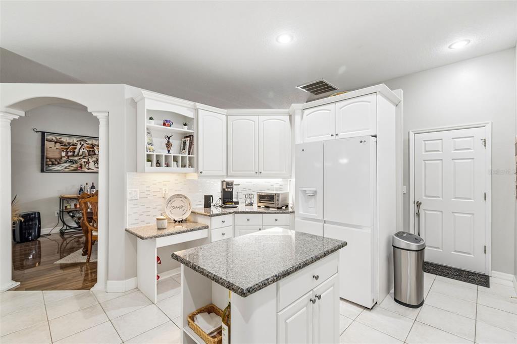 2006 Meadow Rue Court Trinity, FL 34655 - Photo 19 of 96 a kitchen with stainless steel appliances granite countertop a sink stove and refrigerator