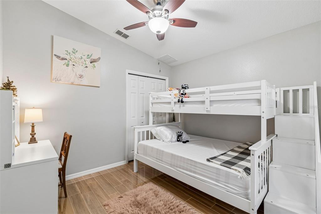 2006 Meadow Rue Court Trinity, FL 34655 - Photo 27 of 96 a bedroom with furniture and wooden floor