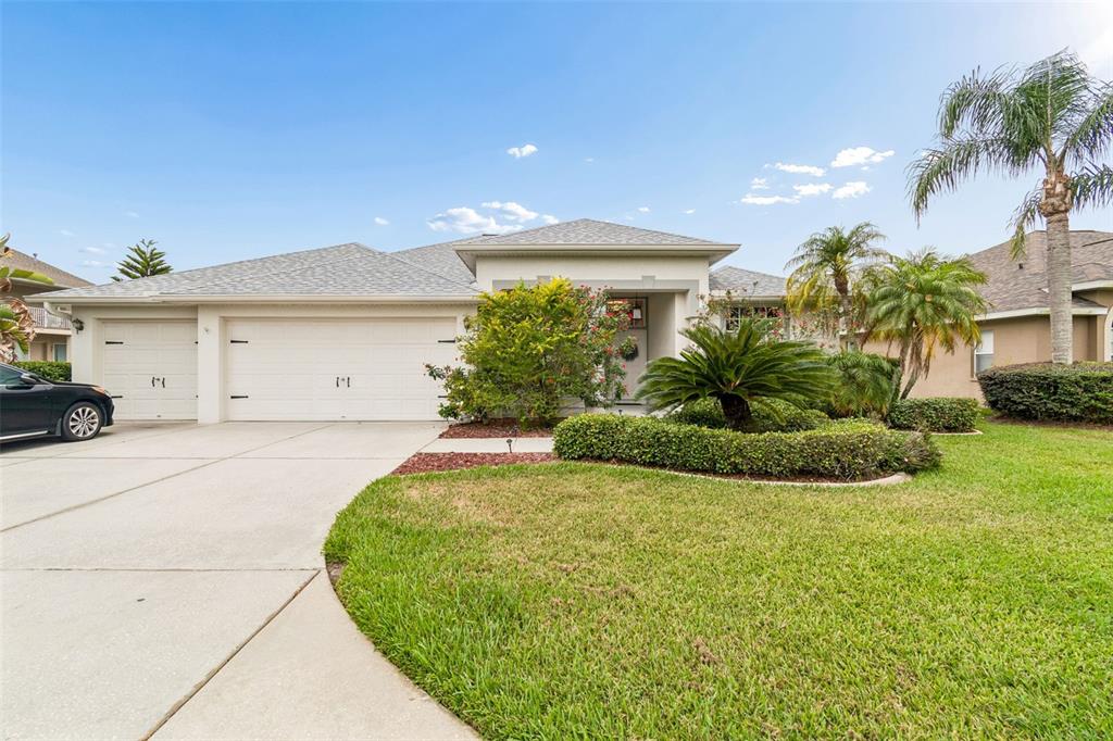 2006 Meadow Rue Court Trinity, FL 34655 - Photo 3 of 96 a front view of a house with a garden and plants