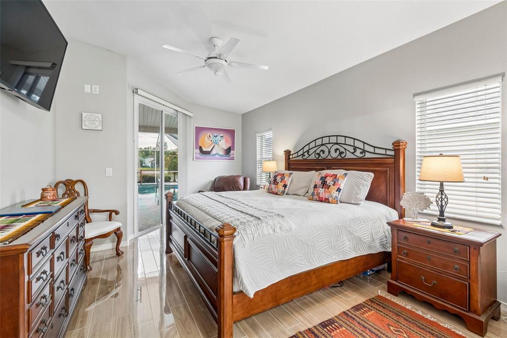 2006 Meadow Rue Court Trinity, FL 34655 - Photo 33 of 96 a bedroom with a bed and a table in it