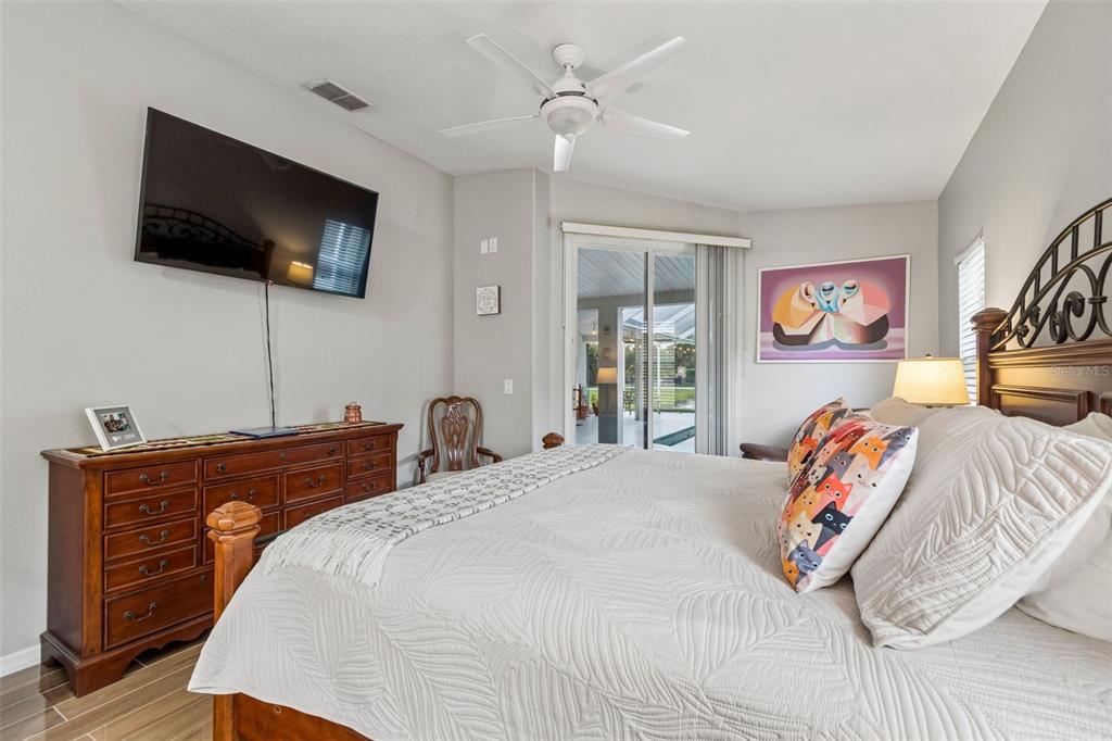 2006 Meadow Rue Court Trinity, FL 34655 - Photo 34 of 96 a bedroom with a bed and a flat screen tv
