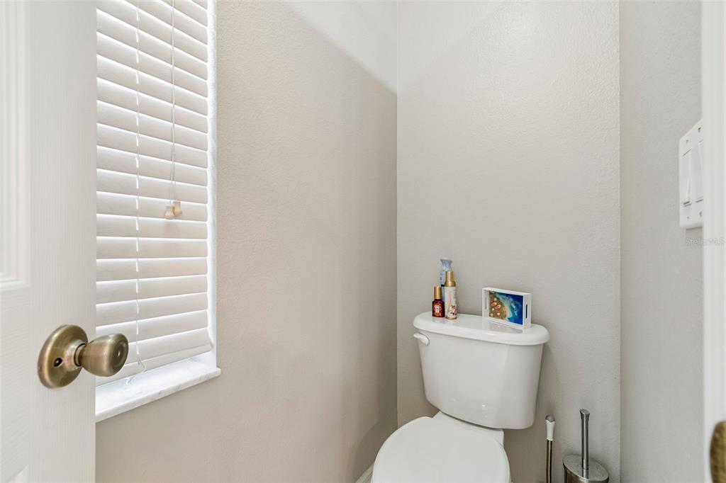 2006 Meadow Rue Court Trinity, FL 34655 - Photo 41 of 96 a white toilet sitting next to a bathroom sink