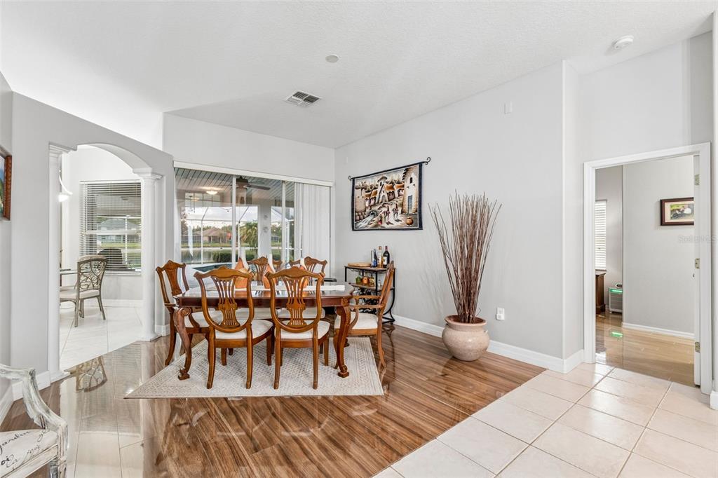 2006 Meadow Rue Court Trinity, FL 34655 - Photo 49 of 96 a view of a dining room with furniture and wooden floor