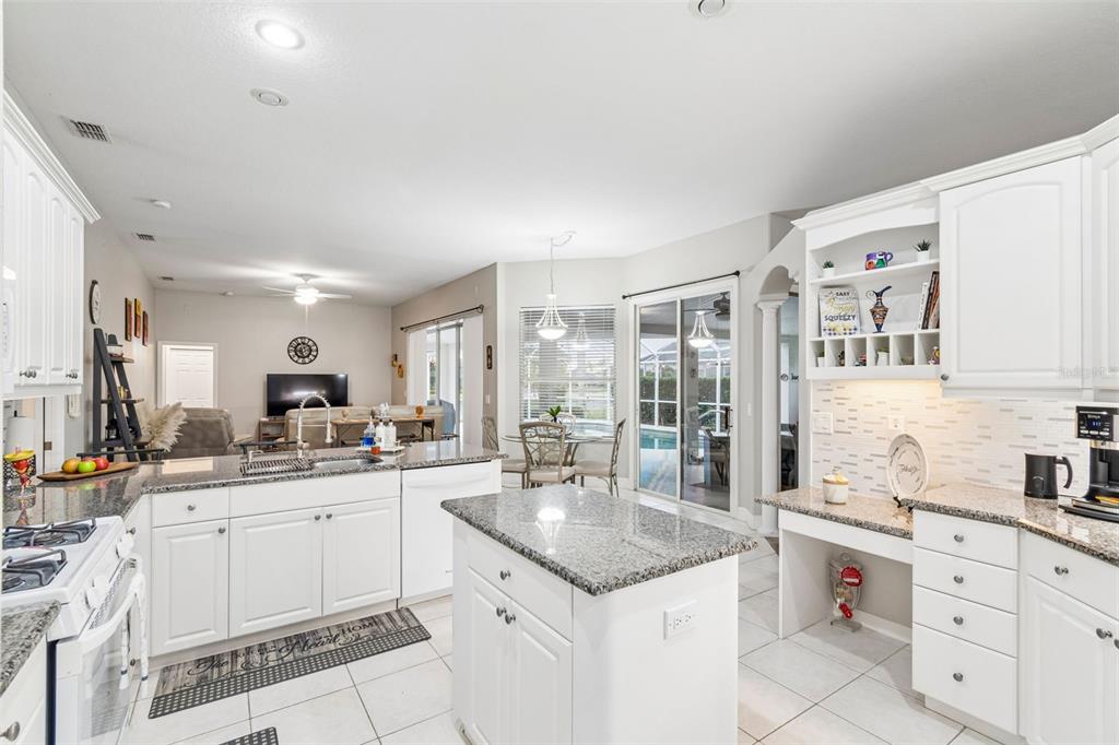 2006 Meadow Rue Court Trinity, FL 34655 - Photo 58 of 96 a kitchen with granite countertop a sink and cabinets