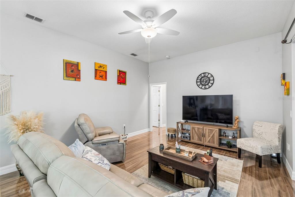 2006 Meadow Rue Court Trinity, FL 34655 - Photo 63 of 96 a living room with furniture and a flat screen tv