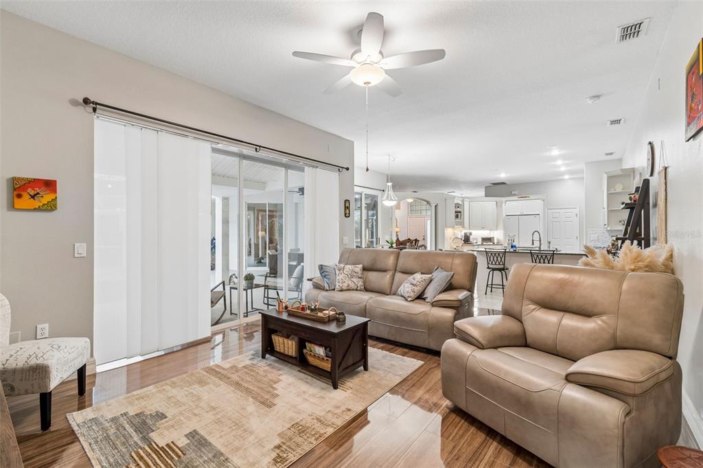 2006 Meadow Rue Court Trinity, FL 34655 - Photo 64 of 96 a living room with furniture a ceiling fan and a rug