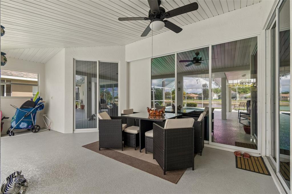 2006 Meadow Rue Court Trinity, FL 34655 - Photo 10 of 96 a dining room with furniture and a floor to ceiling window