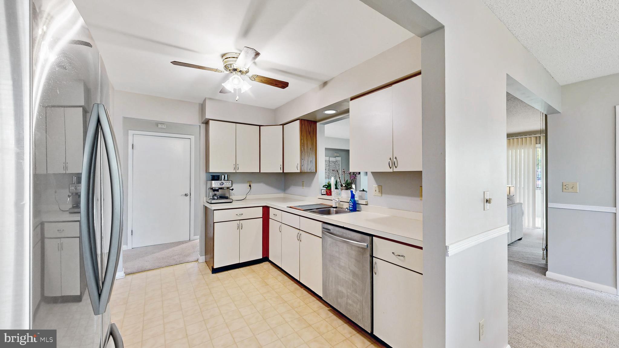 18540 Drayton Hall Road, Unit 2 Lewes, DE 19958 - Photo 11 of 38 a kitchen with cabinets and stainless steel appliances