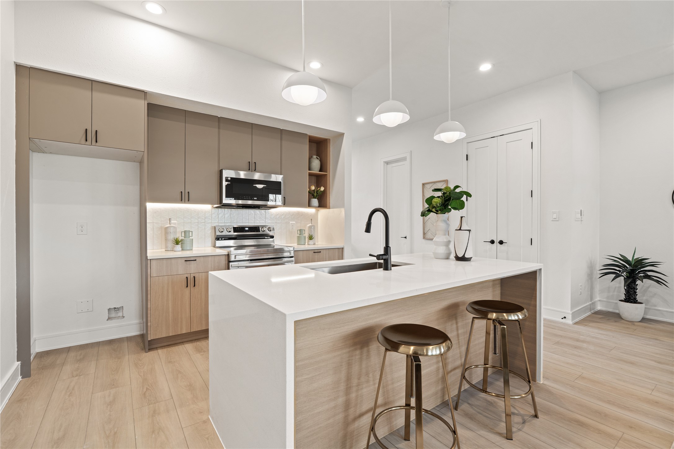 Another view of the open kitchen and living space, emphasizing the airy layout and natural light.
