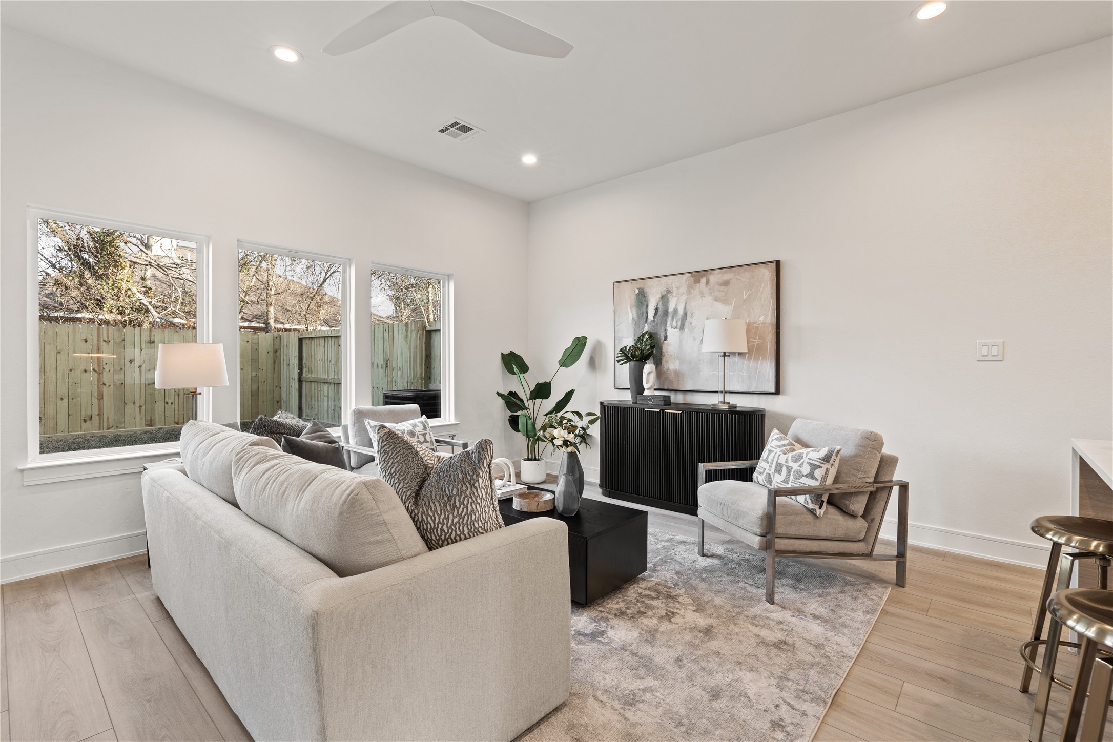 8019 Grandview Street Houston, TX 77051 - Photo 12 of 34 Bright living room with oversized windows, high ceilings, and a calm, airy feel.