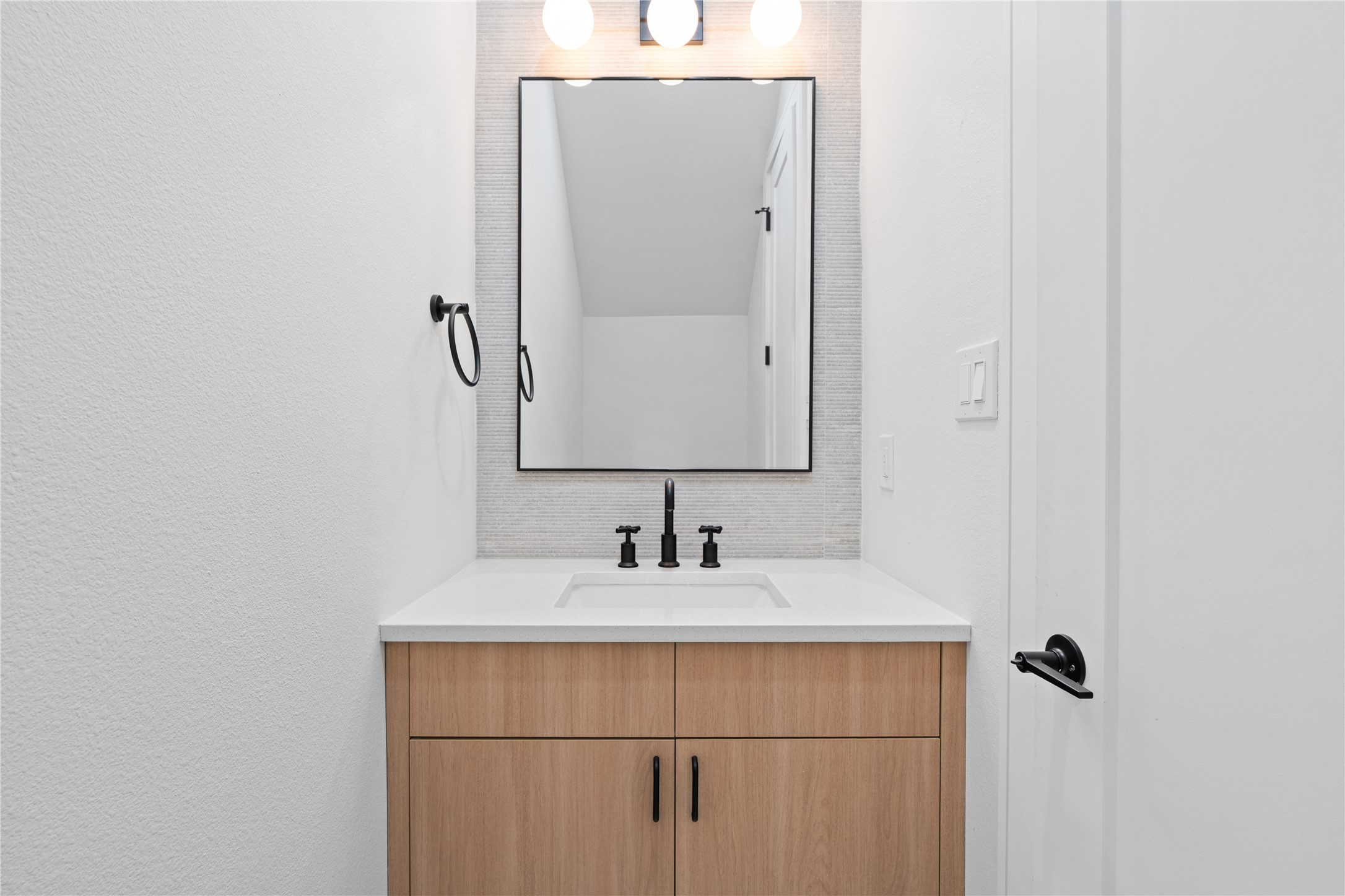 8019 Grandview Street Houston, TX 77051 - Photo 17 of 34 Sleek powder bath with modern vanity, matte black fixtures, and clean finishes.