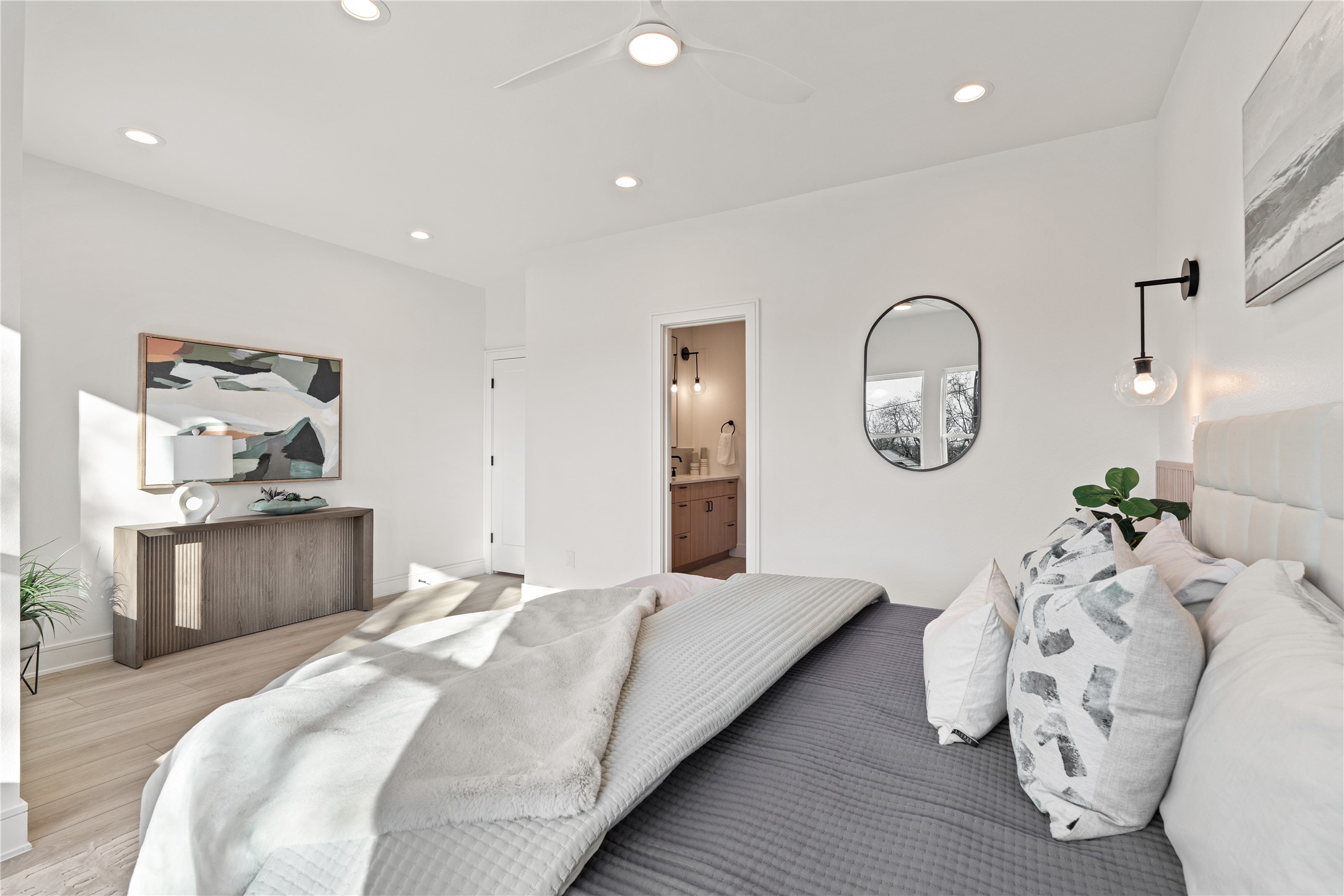 8019 Grandview Street Houston, TX 77051 - Photo 20 of 34 Primary bedroom – angled view showing the bed, dresser, artwork, and doorway to the en-suite bathroom.