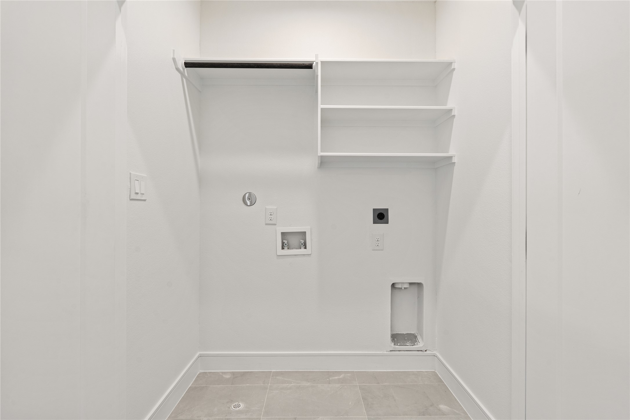 8019 Grandview Street Houston, TX 77051 - Photo 31 of 34 Laundry room with washer/dryer hookups and built-in shelving