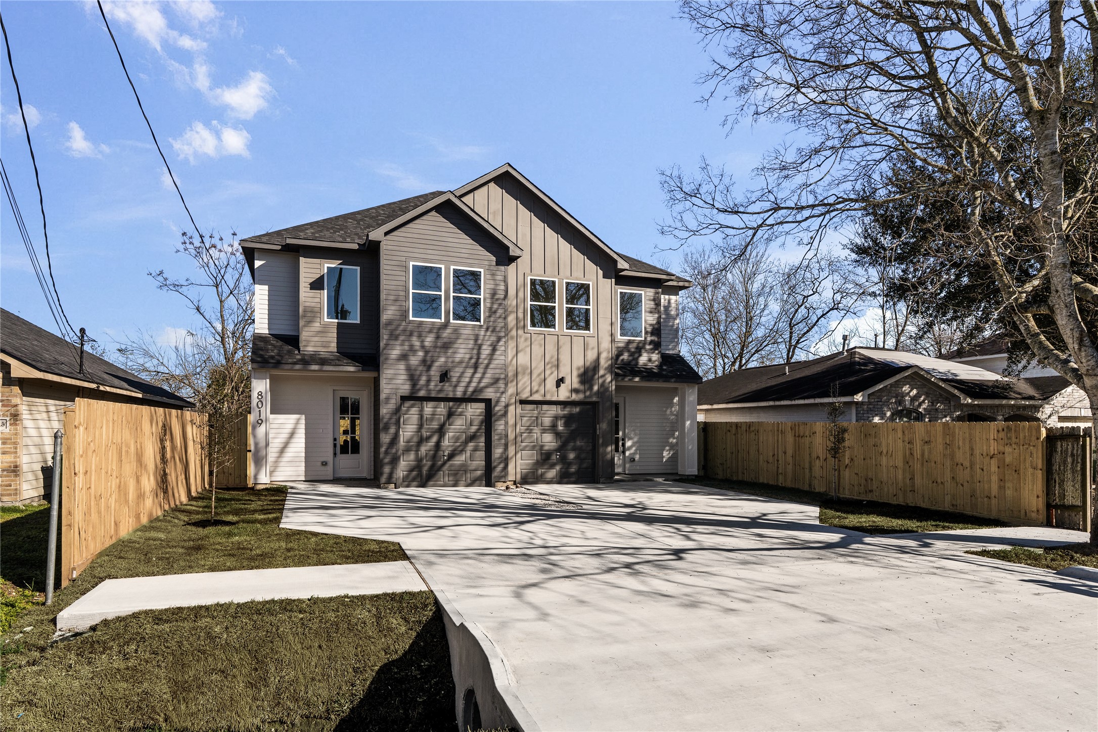 8019 Grandview Street Houston, TX 77051 - Photo 33 of 34 Angled front view highlighting the wide driveway, private fencing, and contemporary design.