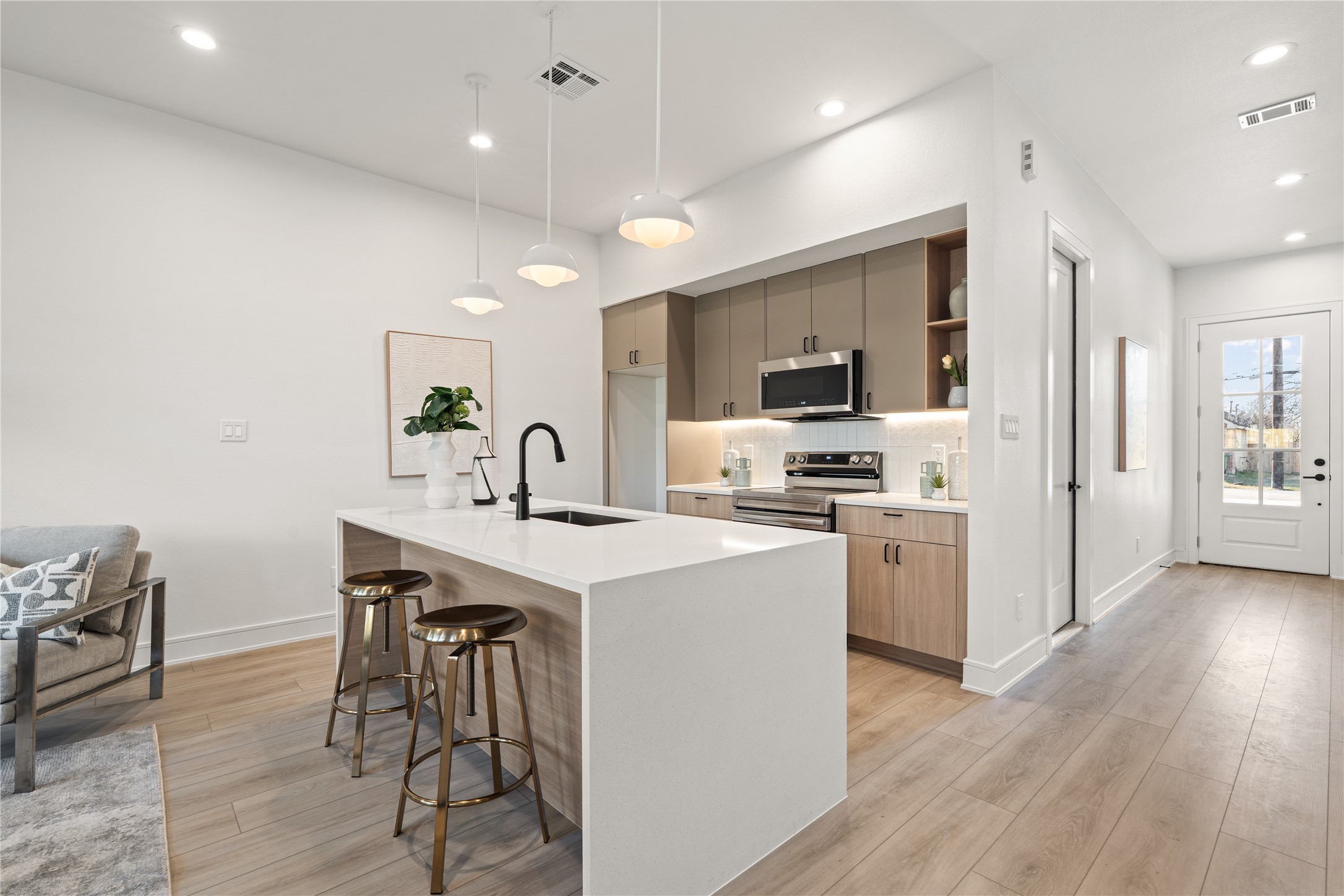 8019 Grandview Street Houston, TX 77051 - Photo 6 of 34 Spacious kitchen featuring a large waterfall island, pendant lighting, and modern finishes.