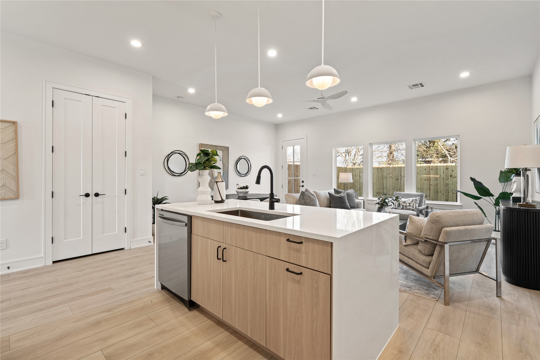 8019 Grandview Street Houston, TX 77051 - Photo 8 of 34 Sleek kitchen with stainless steel appliances, warm wood cabinetry, and under-cabinet lighting.
