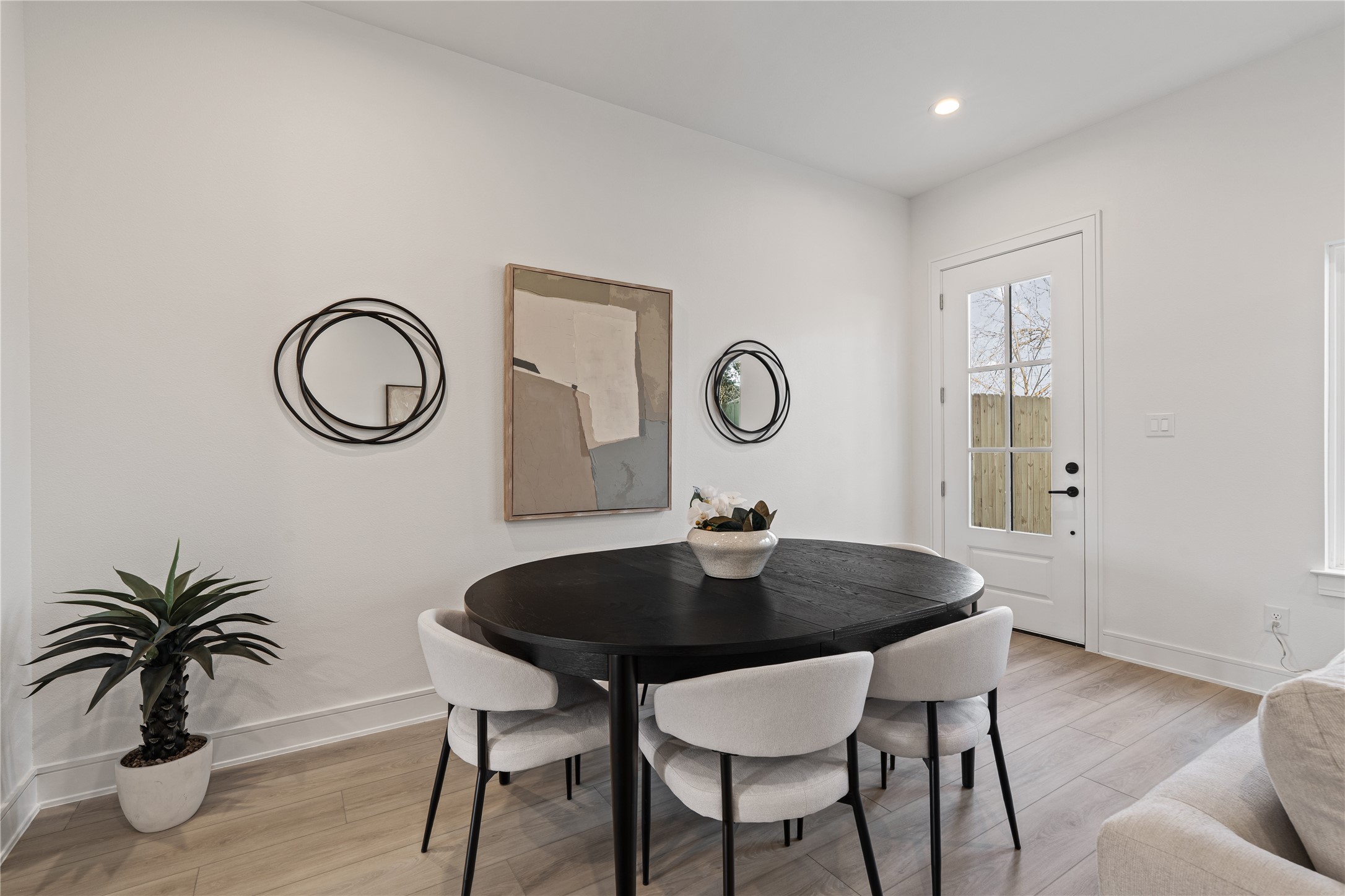 8019 Grandview Street Houston, TX 77051 - Photo 10 of 34 Modern dining area with a round table, clean lines, and easy flow to the backyard.