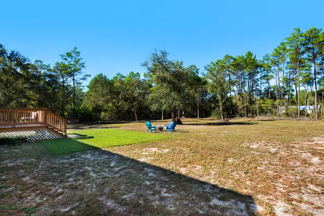 a view of a swimming pool with a yard