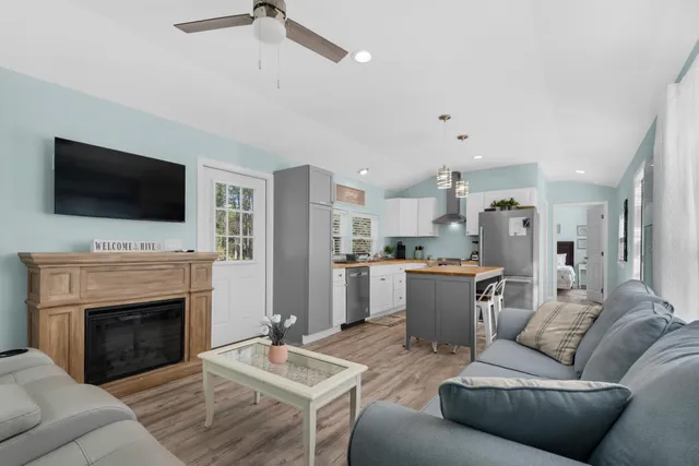 a living room with furniture a fireplace and a flat screen tv