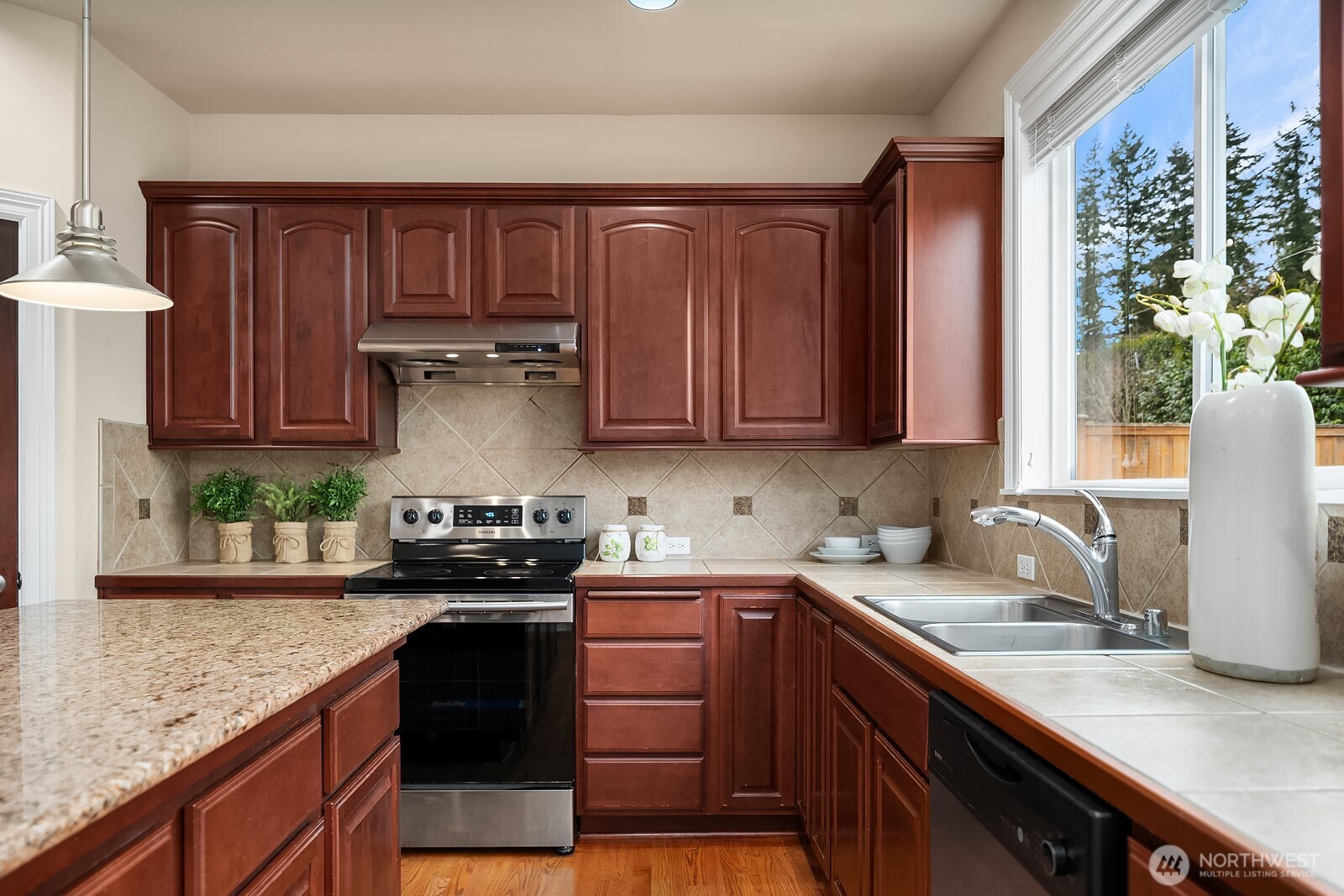 5504 Northeast 13th Place Renton, WA 98059 - Photo 11 of 36 a kitchen with stainless steel appliances granite countertop a sink stove and cabinets