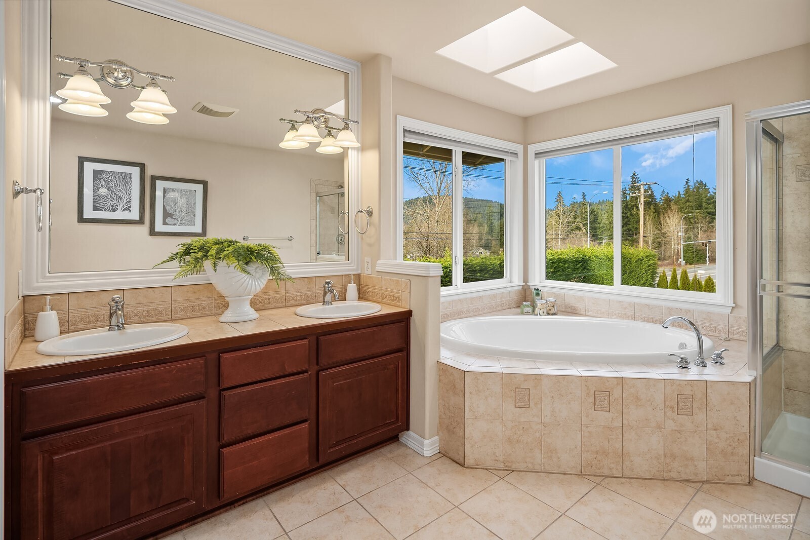 5504 Northeast 13th Place Renton, WA 98059 - Photo 24 of 36 a spacious bathroom with a tub sink and mirror