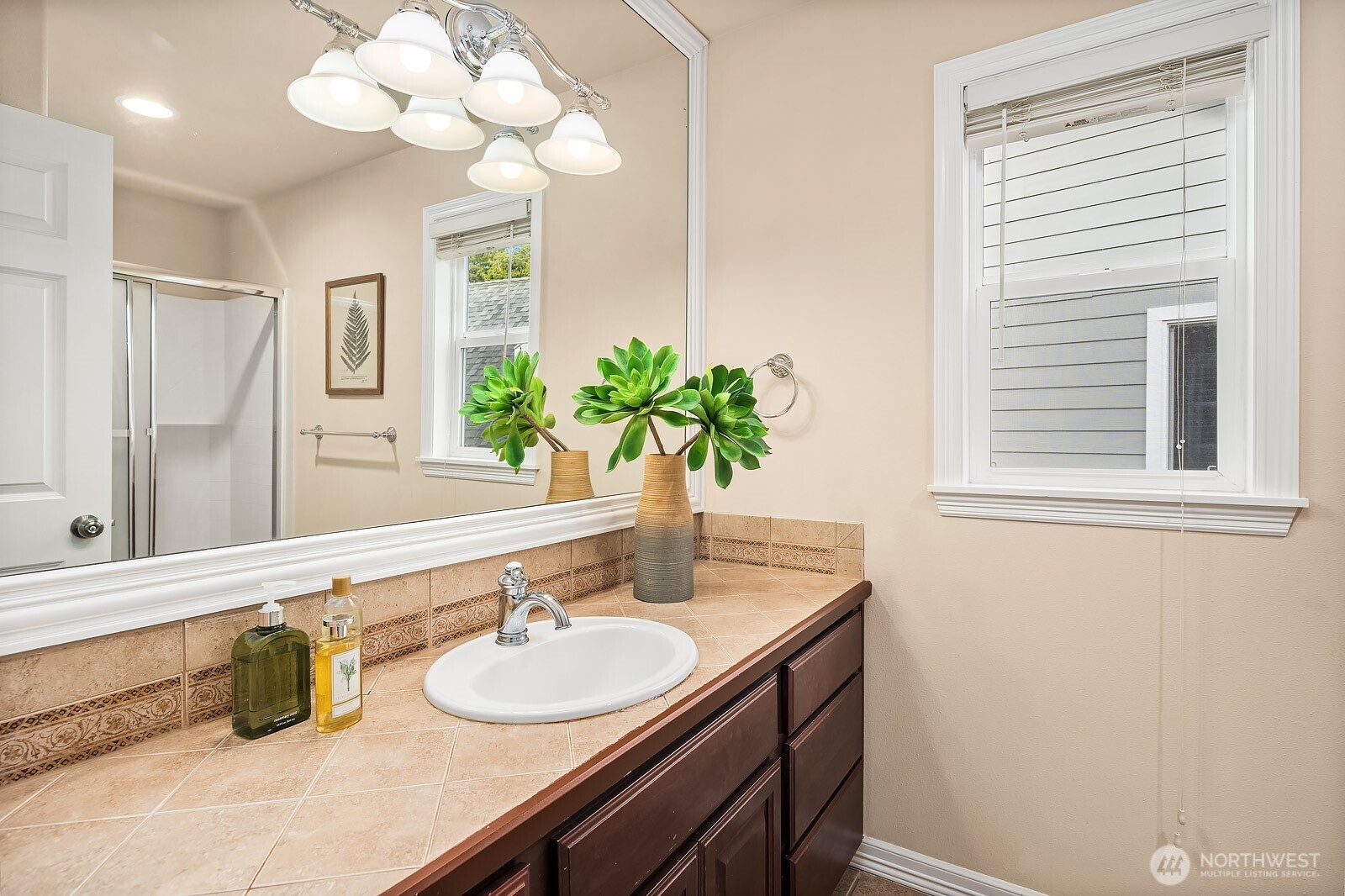 5504 Northeast 13th Place Renton, WA 98059 - Photo 31 of 36 a bathroom with a sink a large mirror and a window