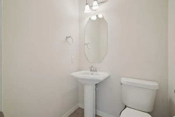 a bathroom with a sink a mirror and a toilet