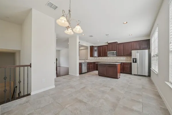 a large kitchen with cabinets and stainless steel appliances