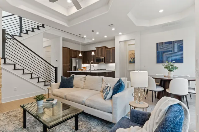 a living room with furniture and kitchen view