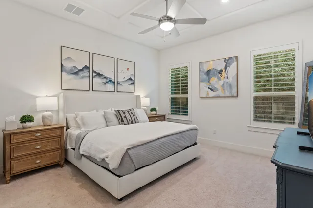 a bedroom with a bed and ceiling fan