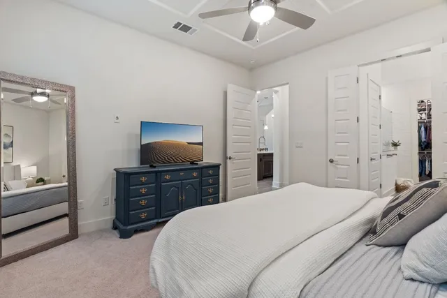 a bedroom with a bed and ceiling fan