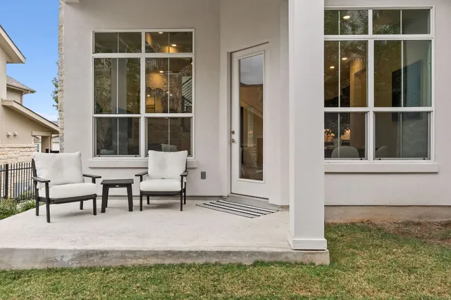 a view of a house with backyard and sitting area