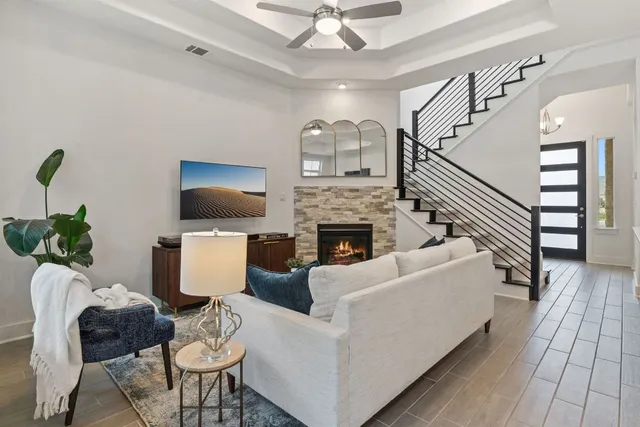 a living room with furniture a flat screen tv and a fireplace