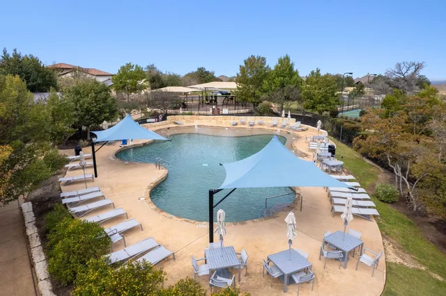 a swimming pool with outdoor seating and yard