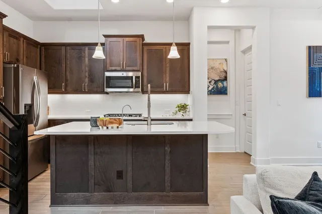 a kitchen with stainless steel appliances a sink stove and refrigerator