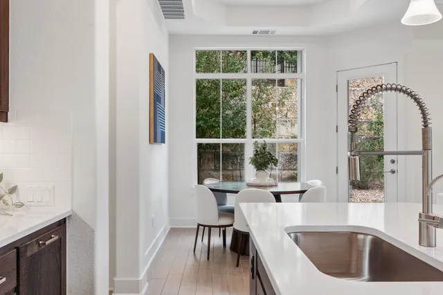 a view of a kitchen area with furniture and wooden floor