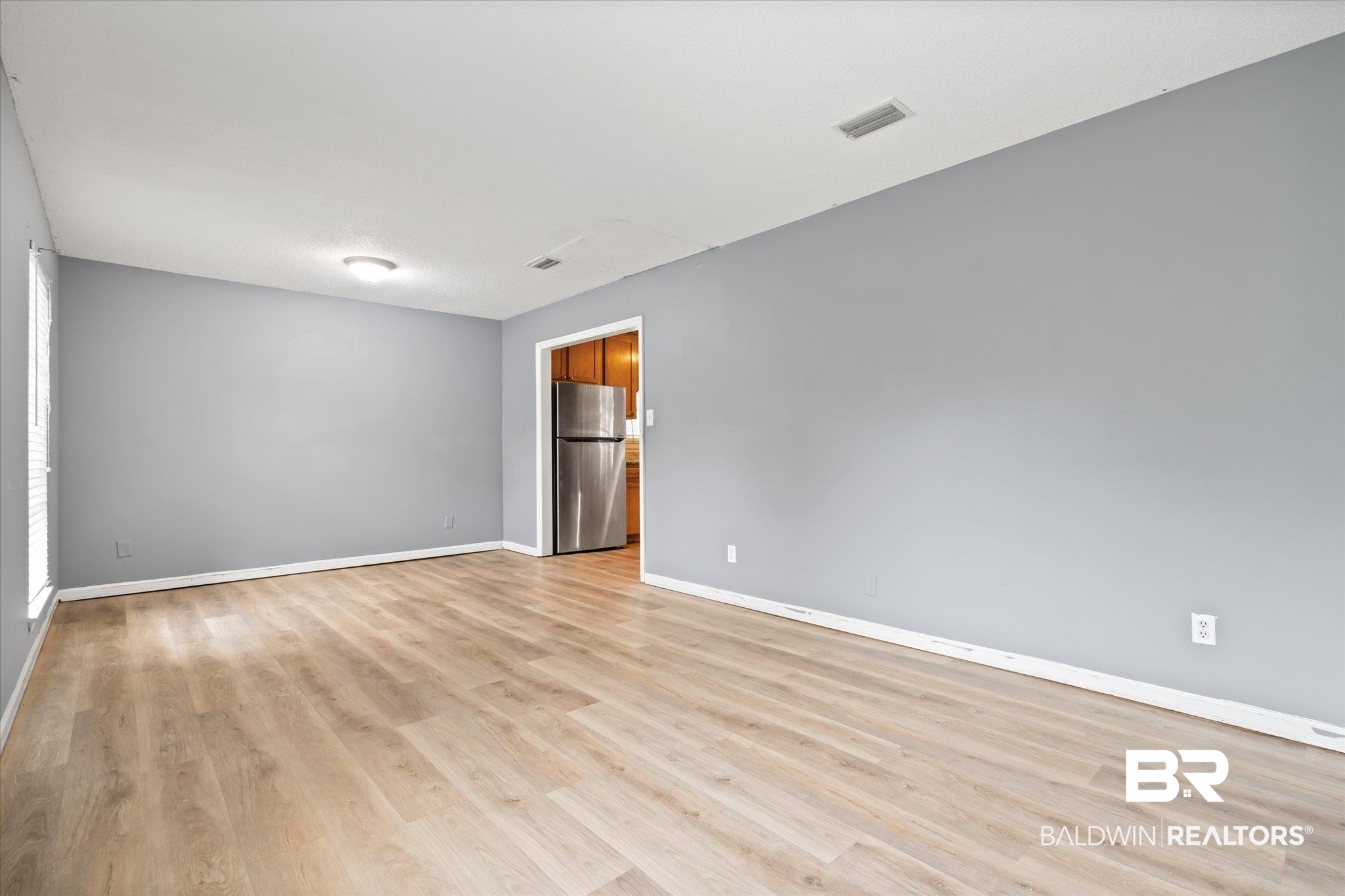 9445 Howells Ferry Road Semmes, AL 36575 - Photo 3 of 20 Unfurnished room featuring light hardwood / wood-style floors