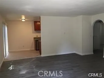a view of a kitchen with wooden floor and a refrigerator