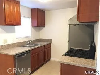 a kitchen with a sink and a stove top oven