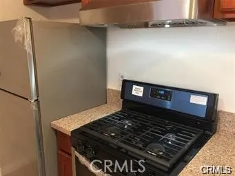 a stove top oven sitting inside of a kitchen