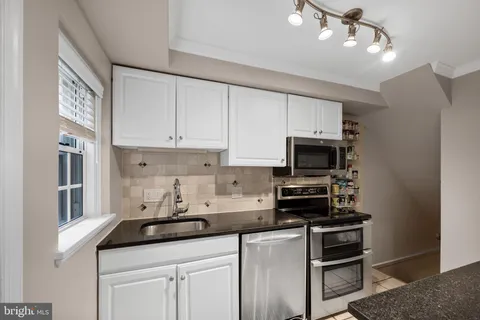 a kitchen with a stove and a microwave