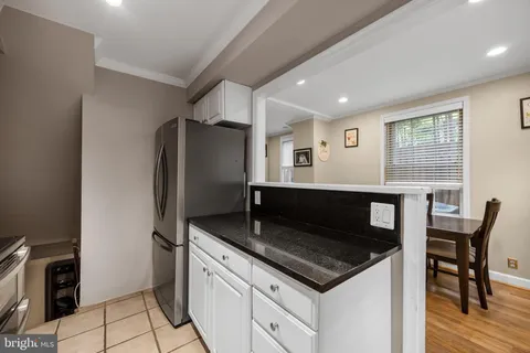 a bedroom with a bed and a night stand