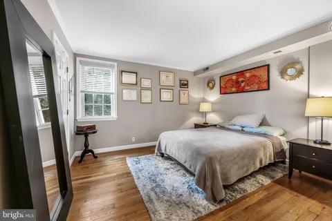 a bedroom with a bed and a lamp